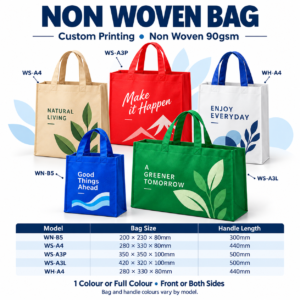 Five custom printed non woven bags in blue, beige, red, green and white with navy handles on a white background.